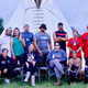 The marchers stand before a tipi.
